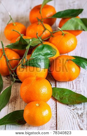 Tangerines With Leaves On A Wooden Table