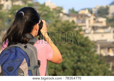 woman tourist taking photo at fenghuang ancient town,china