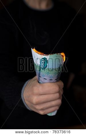 Pack Of Burning Rubles In Person's Hand
