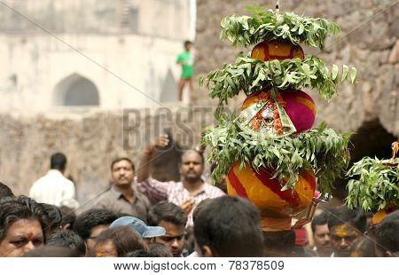 Hindu devotees carry Bonam to the temple