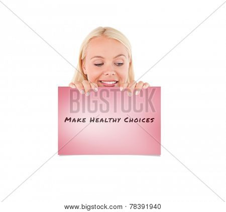 Woman peeking over a whiteboard against pink card