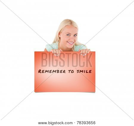 Smiling woman standing behind a whiteboard against orange card