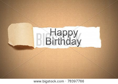 Brown Paper Torn To Reveal Happy Birthday