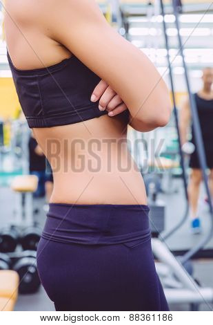 Slim waist closeup of sporty woman with black sportswear