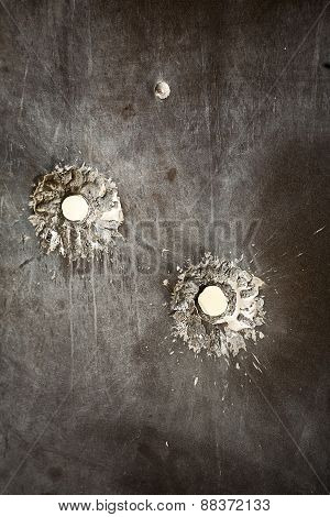 Bullet holes in metal surface