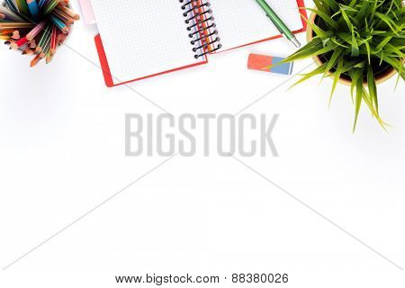 Office desk table with supplies and flower. Isolated on white background. Top view with copy space