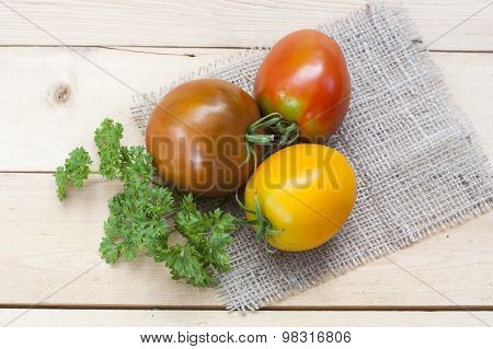 Assorted tomatoes: orange, pink, black tomatoes with parsle