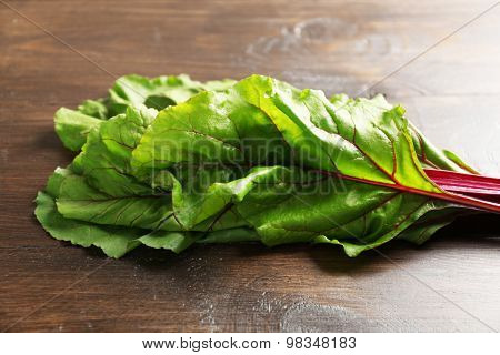 Fresh swiss chard on wooden table, close up