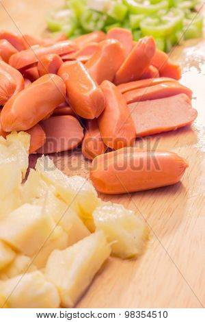 Preparing sausage and vegetables woman hands vintage tone.