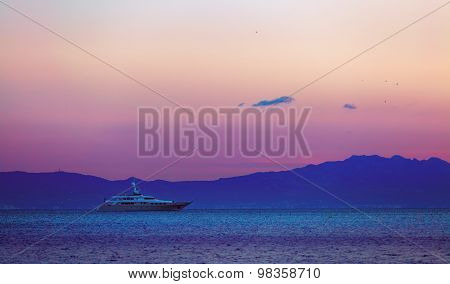 Pink sunset at sea and two ships stand