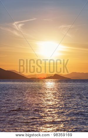 Beautiful Sunset on the sea, in the background mountains