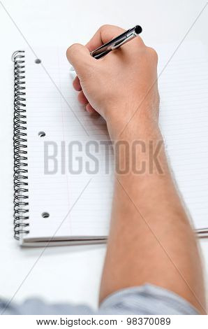 Man's Hand Drawing In A Notebook