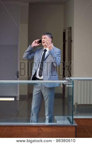 business man using phone at modern office space