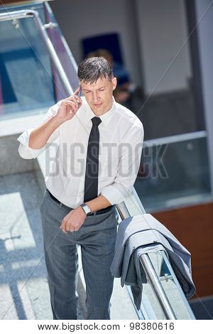 business man using phone at modern office space