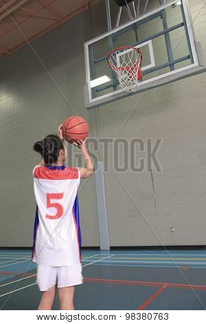 A asian basketball player in gymnase field