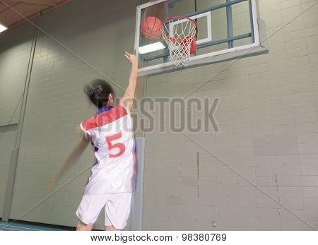 A asian basketball player in gymnase field