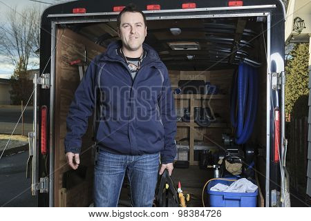 Portrait of an happy worker with tool