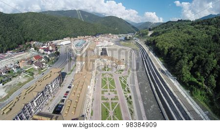 SOCHI, RUSSIA - AUG 1, 2014: The new building of hotel complex Gorky Gorod Apartments in Krasnaya Polyana, aerial view