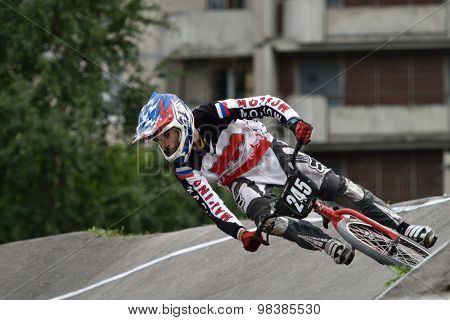 ST. PETERSBURG, RUSSIA - AUGUST 6, 2015: Unidentified biker on the berm in the BMX race Cruiser. The competitions is a stage of the BMX racing championship of Russia