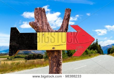 Belgium Flag wooden sign with road background