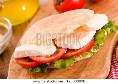 Puccia bread with mozzarella lettuce and tomato.