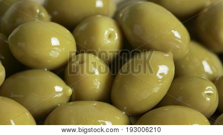 Large shiny green olives macro for background