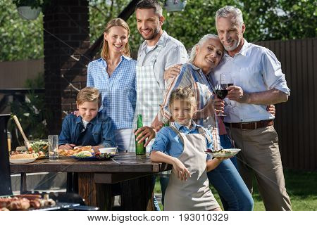 Happy Caucasian Multi-generational Family Having Picnic On Patio At Daytime