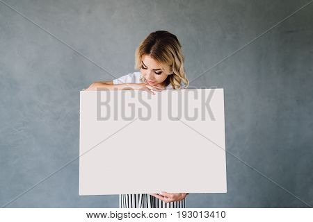 Portrait of a young professional business woman standing next to a presentation easel with copy space