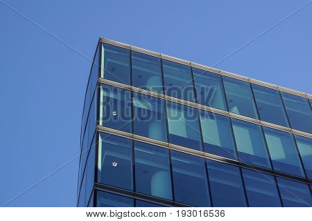 Perspective and underside angle view to textured background of contemporary glass building skyscrapers