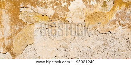 Old vintage grungy plaster beige painted wall texture background