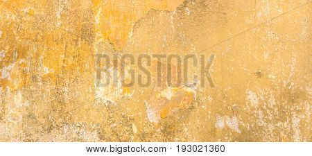 Old vintage grungy plaster beige painted wall texture background
