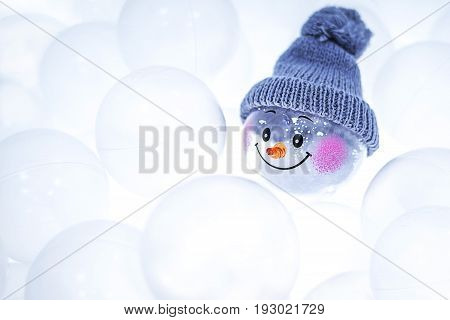 Transparent white plastic balls for the game room. Rest for adults and children. In the balls is a toy snowman. Focus on the toy.