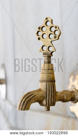 Turkish Ottoman style antique ablution tap at the ablution fountain in front of Fatih Mosque Istanbul Turkey