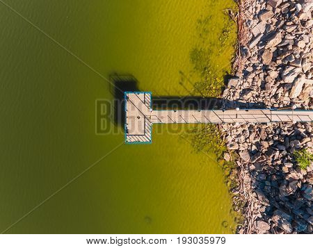 Aerial view of ocean beach. Sand beach and pier view from above. Beach aerial view of ocean water and sand shore. Aerial shot of beach