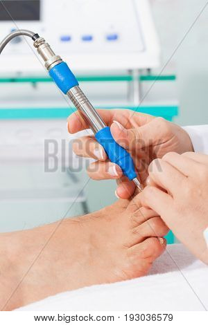 Doctor using electro acupuncture equipment for diagnostic