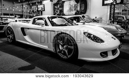 MAASTRICHT NETHERLANDS - JANUARY 15 2016: Supercar Porsche Carrera GT 2005. Black and white. International Exhibition InterClassics & Topmobiel 2016
