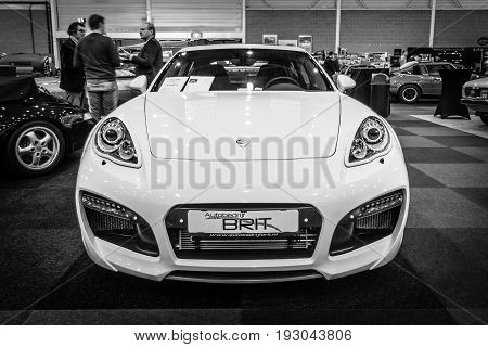 MAASTRICHT NETHERLANDS - JANUARY 15 2016: Full-size luxury car Porsche Panamera Grand GT 2012. Black and white. International Exhibition InterClassics & Topmobiel 2016