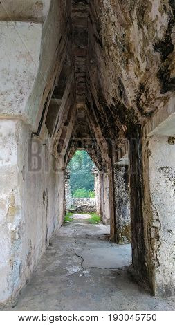 Unusual triangular perspective through stone archway of archeological ruins, Palenque, Mexico.