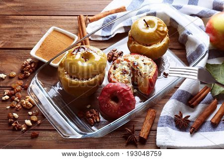 Composition with tasty baked apples and cinnamon on wooden table