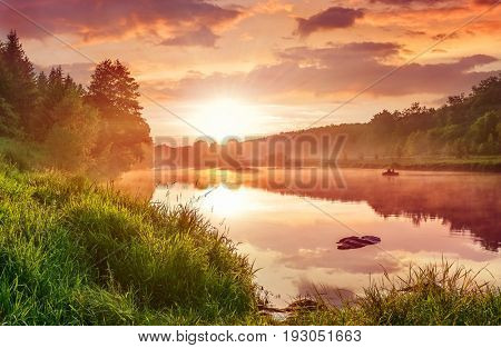 Landscape with sunset on the lake. Matutinal picturesque morning sky clouds in water sunbeam forest.