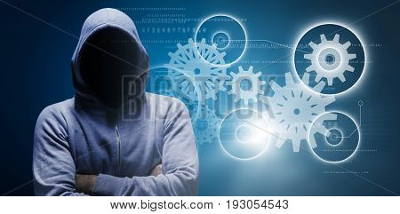 Hacker standing with arms crossed against blue background with vignette