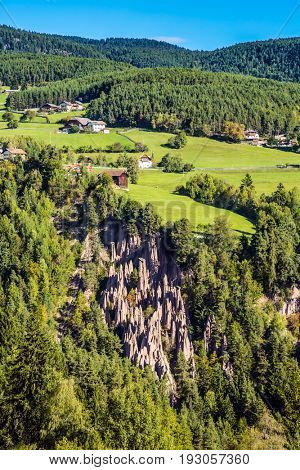  Tirol, Italy. The charming small village in the Dolomites. Renon's earth pillars at sunrise. The concept of ecological tourism 
