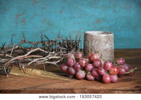 Communion table with crown of thorns, cup, grapes and wheat