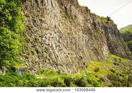 Mountain landscape with unique geological formation called Symphony of Stones. Basalt rock. Ecotourism. Nature background. Adventure holiday. Armenia, Garni. Travel vacation. Climbing tourism concept