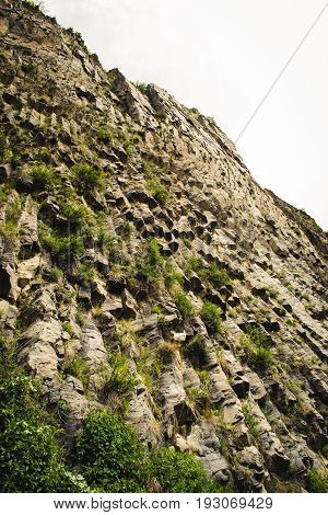 Mountain unique geological formation called Symphony of Stones. Basalt rock organ. Eco tourism. Nature background. Adventure holiday. Armenia, Garni. Travel vacation. Climbing tourism concept.Caucasus