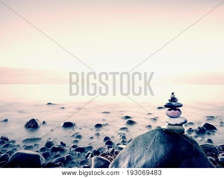 Rounded Colorful Stones Stand In The Form Of Pyramid Big Rounded Stone At Sea