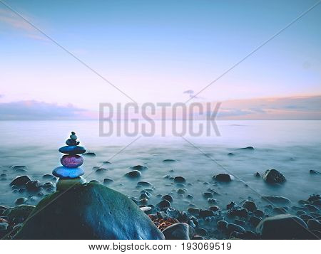 Rounded Colorful Stones Stand In The Form Of Pyramid Big Rounded Stone At Sea