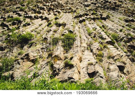 Mountain unique geological formation called Symphony of Stones. Basalt rock. Ecotourism. Nature background. Adventure holiday. Armenia, Garni. Travel vacation. Climbing tourism concept. Horizontal