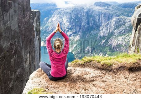 Happy people relax in cliff during trip Norway. Kjerag hiking route.