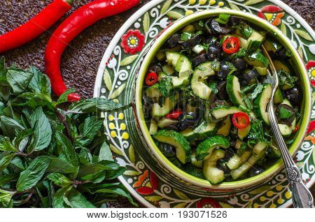 Salad with cucumbers olives chili and mint